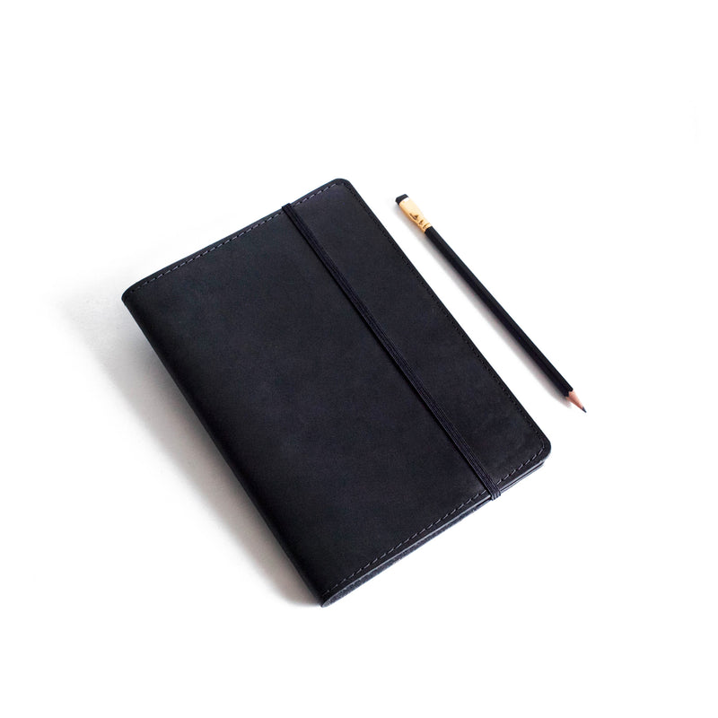 Black Classic Journal next to pencil