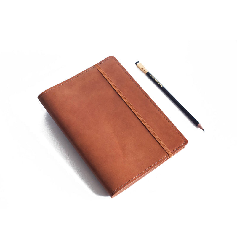 Brown Classic Journal next to pencil